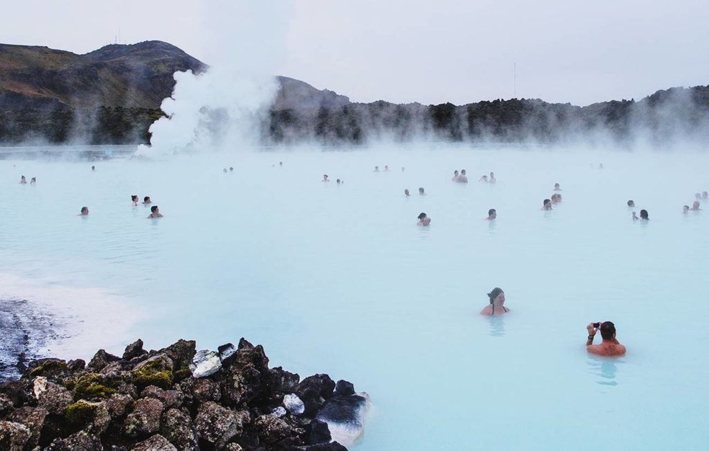 A group of people in the water at a hot spring.