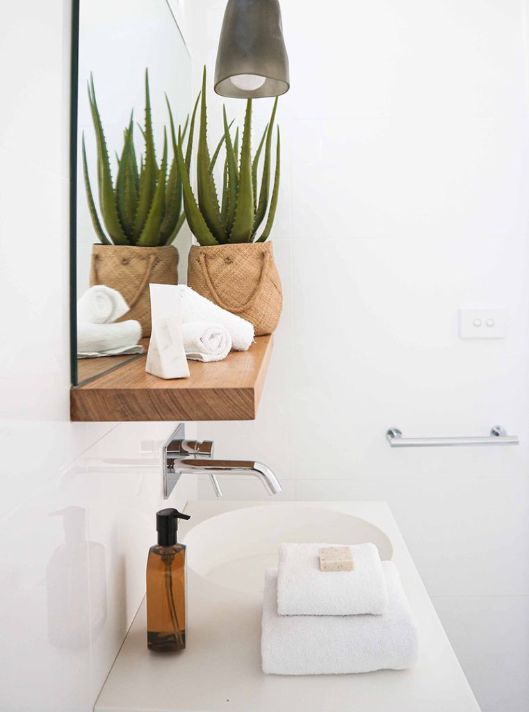 A bathroom with a sink and mirror